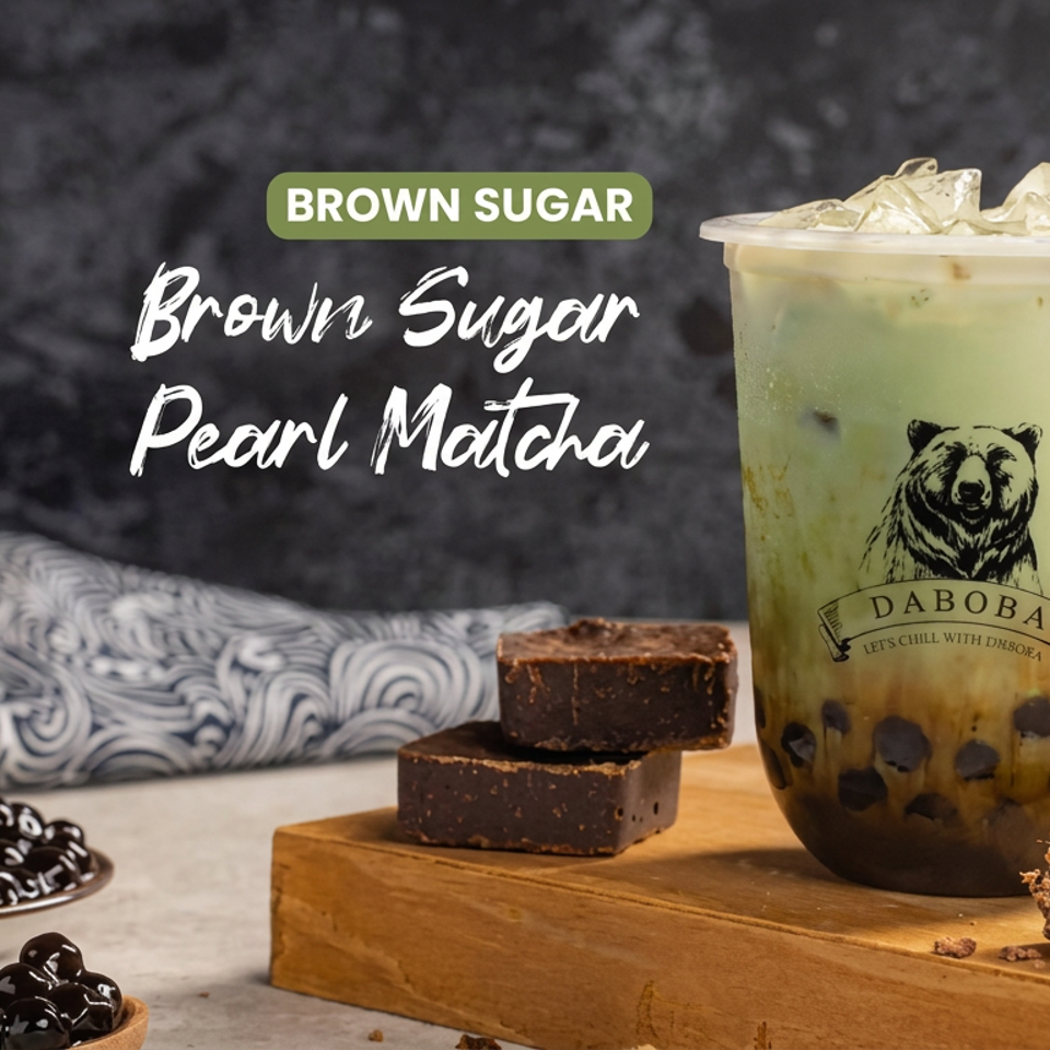 Brown Sugar Pearl Matcha drink with tapioca pearls, brownie pieces, and extra pearls arranged on a wooden board.